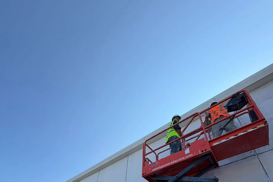 KD Plastering renderers on a scissor lift working along the external wall of an Asda store in Bristol