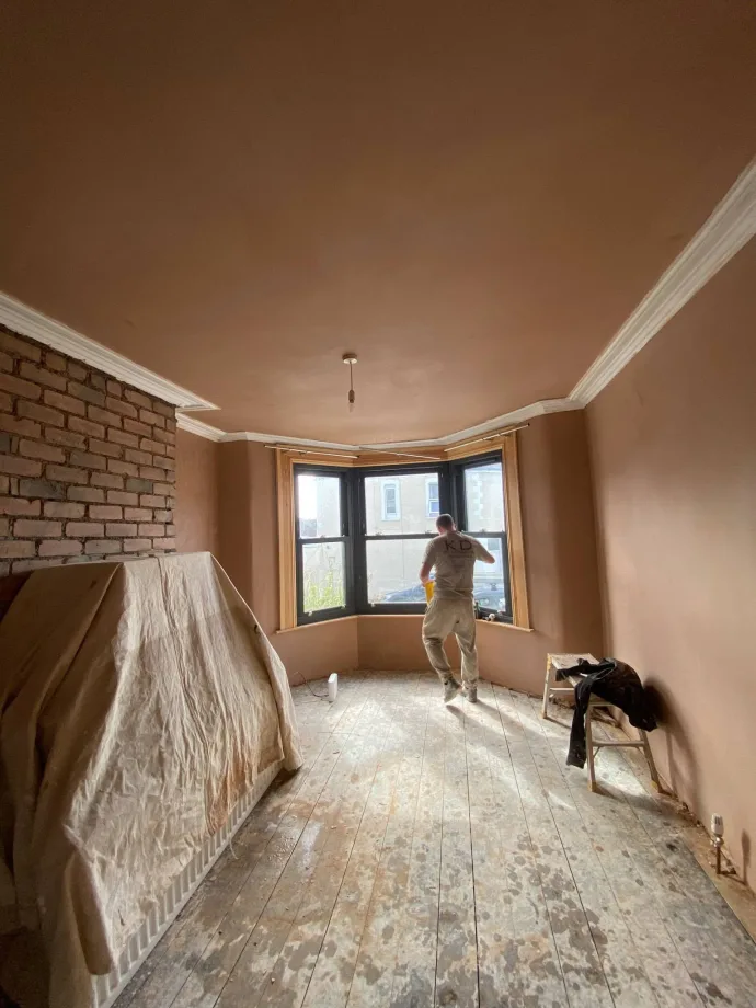 Victorian bay-window room skimmed throughout with original coving and an exposed brick chimney breast